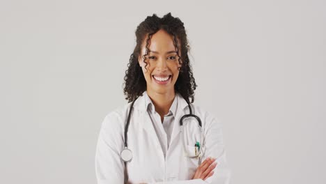Video-of-portrait-of-smiling-biracial-female-doctor-with-arms-crossed