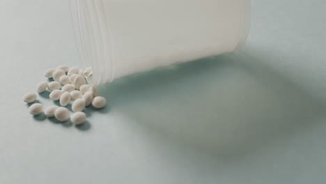 Video-of-close-up-of-box-of-white-pills-on-white-background