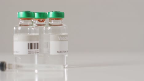Video-of-close-up-of-vaccine-vials-on-white-background