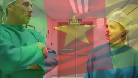 Animation-of-flag-of-cameroon-over-caucasian-doctors-talking