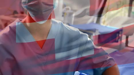 Animation-of-flag-of-switzerland-over-biracial-female-doctor-with-face-mask