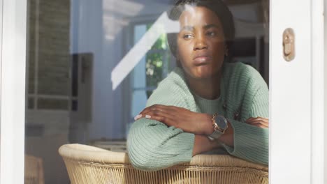 Video-of-sad-african-american-woman-looking-outside-window