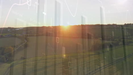 Animation-of-financial-graphs-over-agricultural-field-and-landscape