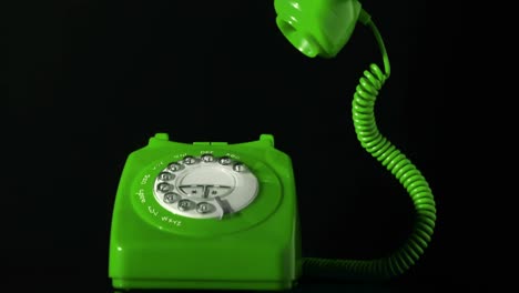 Animation-of-green-phone-on-black-background