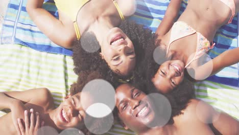 Animation-of-light-spots-over-happy-african-american-family-at-beach