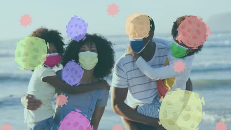Animation-of-virus-cells-over-african-american-family-with-face-masks-on-sunny-beach