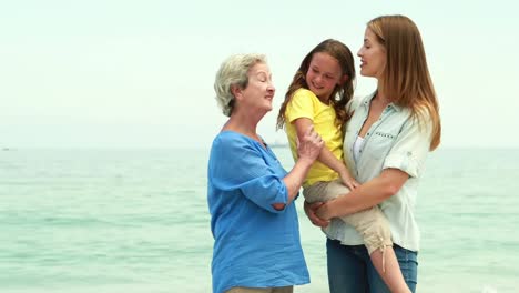 Animation-of-do-it-for-them-over-happy-grandmother,-mother-and-daughter-on-beach