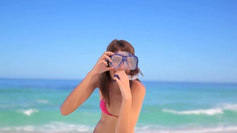 Animation-of-do-it-for-them-over-happy-caucasian-woman-with-snorkeling-equipment-on-beach
