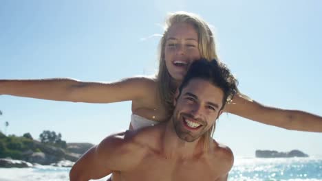 Animation-of-do-it-for-them-over-happy-caucasian-couple-on-beach
