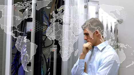 Animation-of-world-map-over-caucasian-businessman-in-server-room