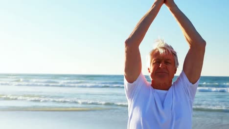 Animation-of-do-it-for-them-over-relaxed-caucasian-senior-man-practicing-yoga-on-beach