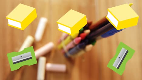 Animation-of-yellow-schoolbooks-and-green-pencil-sharpeners-moving-over-crayons-and-pens-on-desk
