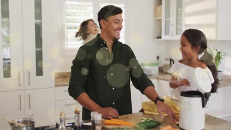 Animation-of-bokeh-over-happy-biracial-family-in-kitchen