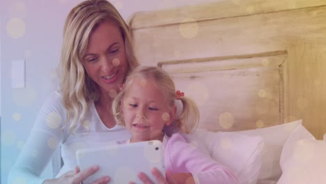 Animation-of-bokeh-over-happy-caucasian-mother-and-daughter-using-tablet