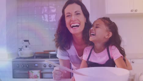 Animation-of-lights-over-happy-caucasisan-mother-and-daughter-cooking-together