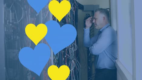 Animation-of-hearts-over-caucasian-businessman-in-server-room