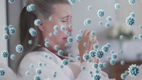 Animation-of-virus-cells-over-caucasian-woman-coughing