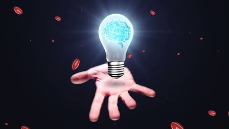 Animation-of-rugby-balls-with-wales-over-caucasian-hand-holding-light-bulb-with-brain