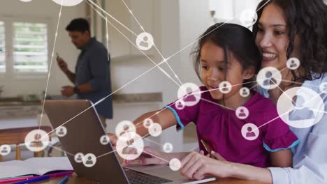 Animation-of-network-of-connections-over-happy-biracial-mother-and-daughter-using-laptop-at-home