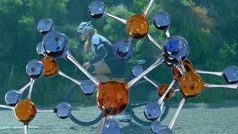Animation-of-molecules-over-caucasian-woman-cycling
