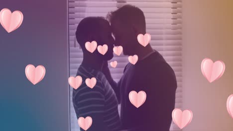 Animation-of-heart-icons-over-diverse-gay-couple-embracing