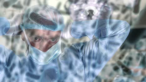 Animation-Von-Covid-19-Zellen-über-Einem-Kaukasischen-Männlichen-Chirurgen-Mit-Gesichtsmaske-Im-Operationssaal