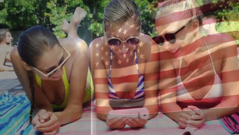 Animation-of-flag-of-usa-over-happy-caucasian-female-friends-having-fun-at-swimming-pool