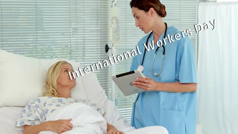 Animation-of-international-workers-day-over-caucasian-female-doctor-talking-with-patient
