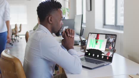 African-american-businessman-using-laptop-for-video-call-with-diverse-business-colleagues
