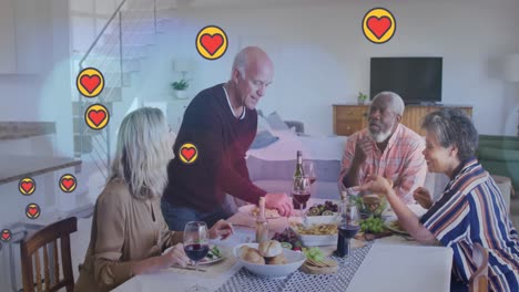Animation-of-hearts-over-diverse-group-of-seniors-eating