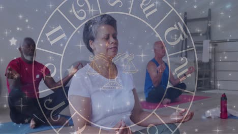 Animation-of-horoscope-over-diverse-group-of-seniors-meditating