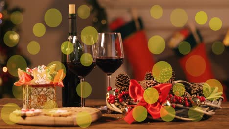 Animation-of-yellow-dots-moving-over-bottle-and-glass-of-wine-and-presents