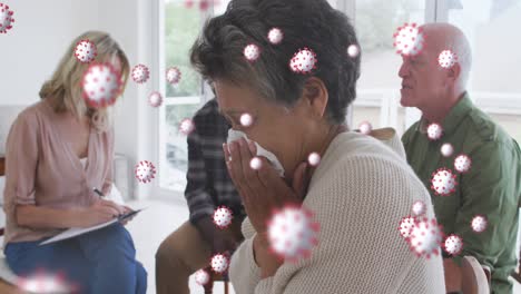 Animation-of-virus-cells-over-diverse-group-of-seniors-talking