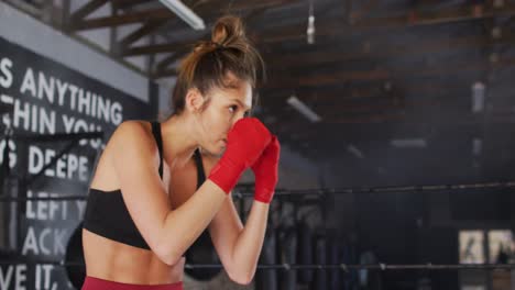 Video-of-fit-caucasian-woman-boxing-at-gym