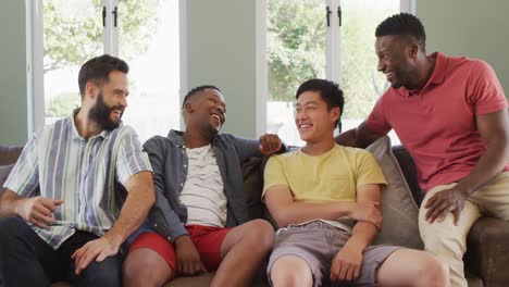 Portrait-of-happy-diverse-male-friends-sitting-and-talking-in-living-room