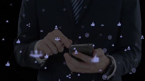 Animation-of-media-icons-over-businessman-using-smartphone