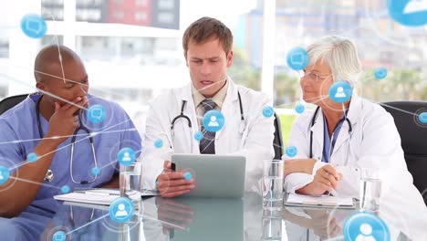 Animation-of-network-of-connections-over-diverse-doctors-working-on-tablet-and-talking