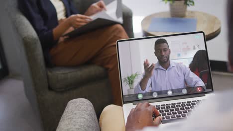 African-american-businessman-using-laptop-for-video-call-with-african-american-business-colleague