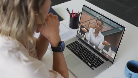 Caucasian-businesswoman-using-laptop-for-video-call-with-african-american-business-colleague