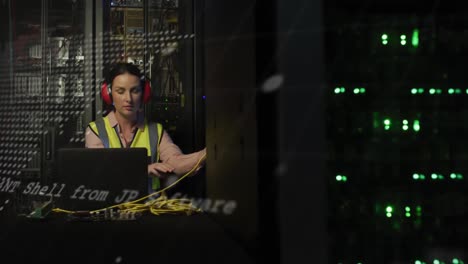 Animation-of-data-processing-over-caucasian-woman-working-on-laptop-in-server-room