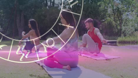 Animation-of-horoscope-zodiac-wheel-over-diverse-people-practicing-yoga
