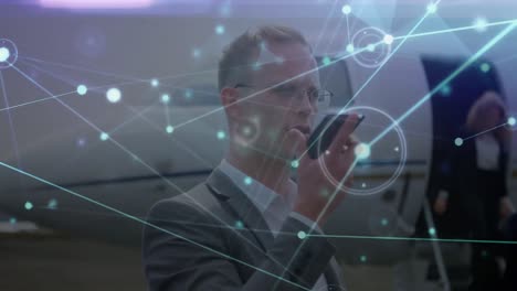 Animation-of-network-of-connections-over-caucasian-businessman-using-smartphone-on-airport