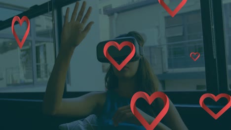Animation-of-hearts-floating-over-caucasian-woman-wearing-vr-headset