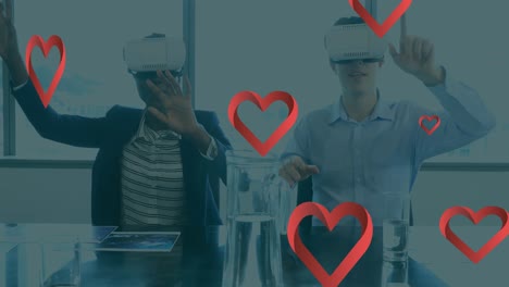 Animation-of-hearts-floating-over-diverse-woman-and-man-wearing-vr-headsets