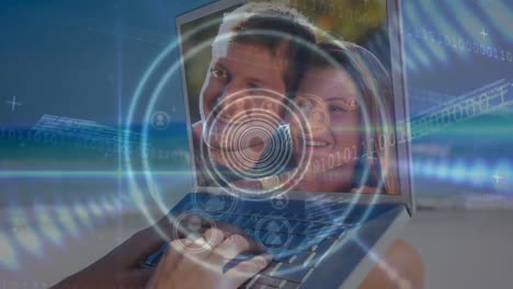 Animation-of-circles-moving-over-laptop-with-caucasian-couple