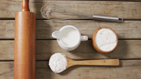 Video-of-baking-ingredients-and-tools-lying-on-wooden-surface