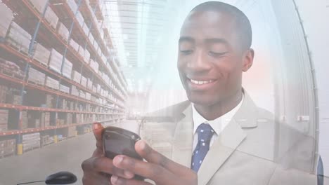 Animation-of-warehouse-over-happy-african-american-man-using-smartphone
