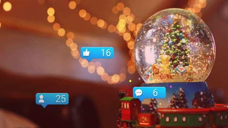 Animation-of-social-media-icons-over-christmas-tree-in-snow-globe