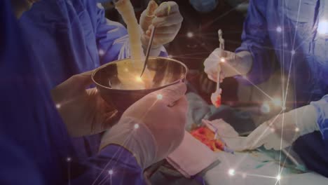 Animation-of-glowing-network-of-connections-over-team-of-surgeons-performing-operation-at-hospital