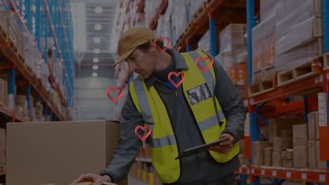 Animation-of-red-hearts-over-caucasian-male-worker-in-warehouse